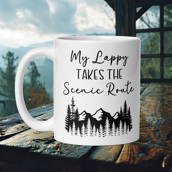 Finnish Lapphund Mug with "My Lappy Takes the Scenic Route" text and mountain tree silhouette—ideal for dog owners and travel lovers.