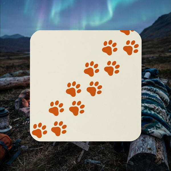Minimalist Finnish Lapphund paw trail cork-back coaster with diagonal paw print design