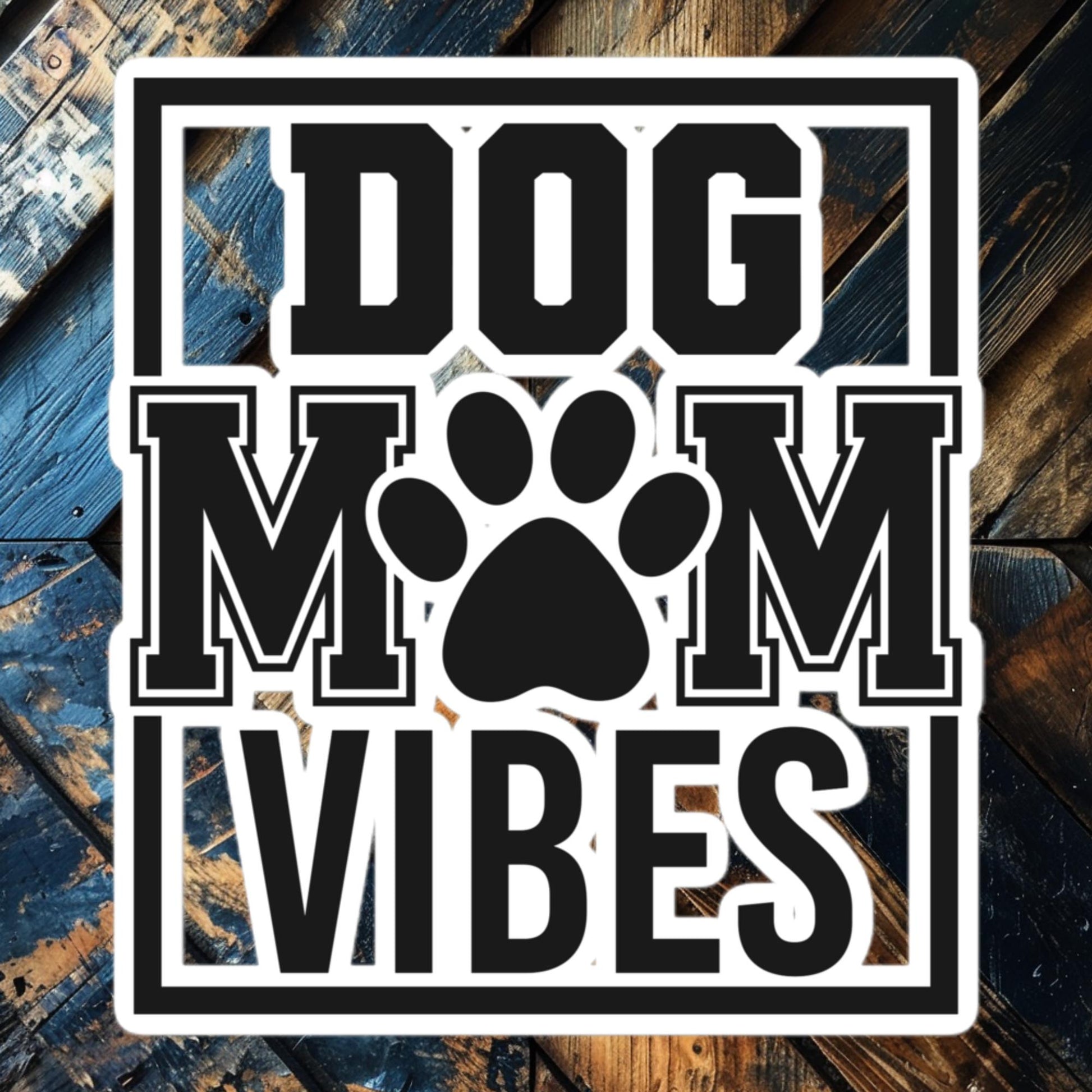 Dog Mom Vibes vinyl sticker featuring bold block letters and paw print, perfect for proud pet parents.