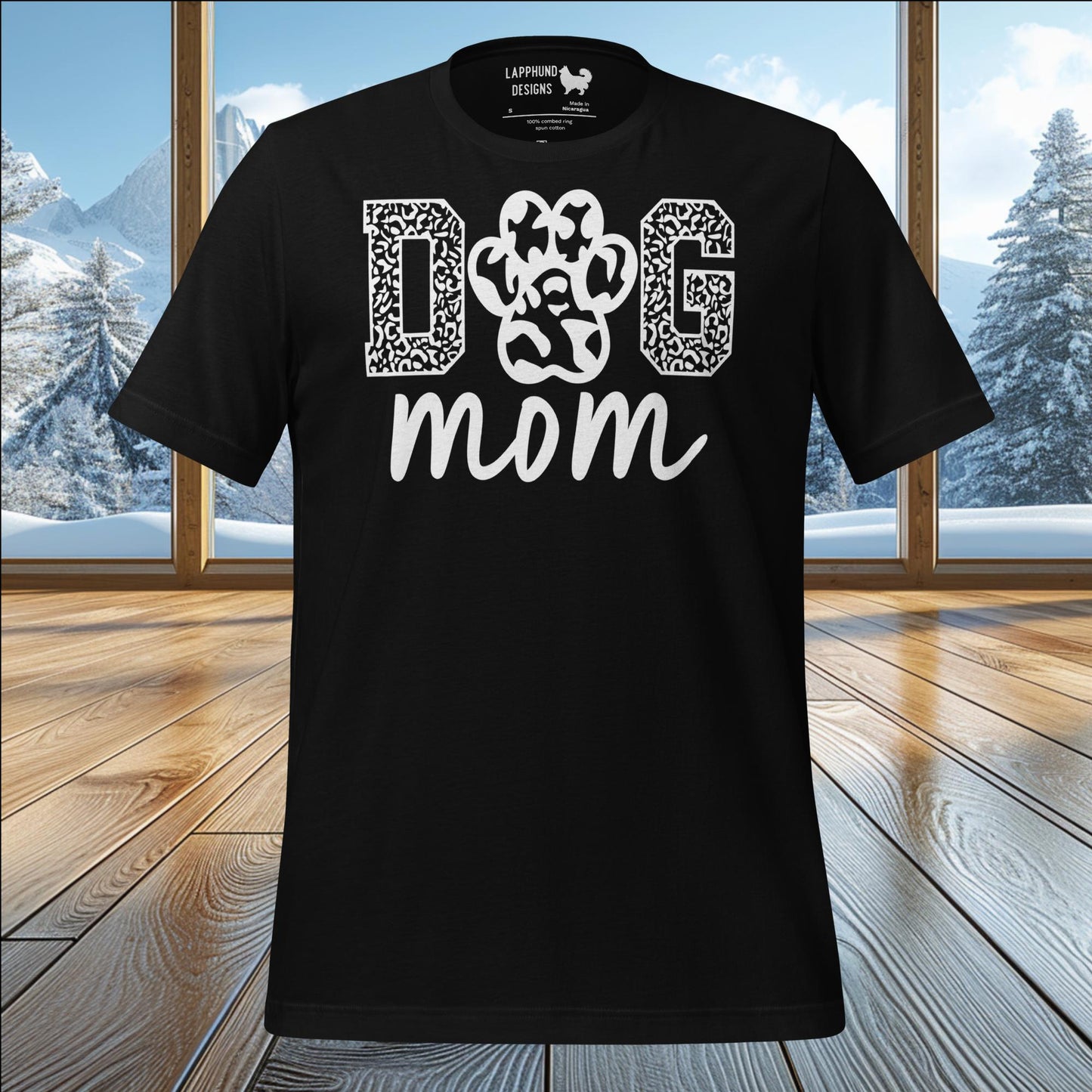 Paw Print Dog Mom t-shirt with bold text, perfect for dog moms who enjoy outdoor adventures and nature.