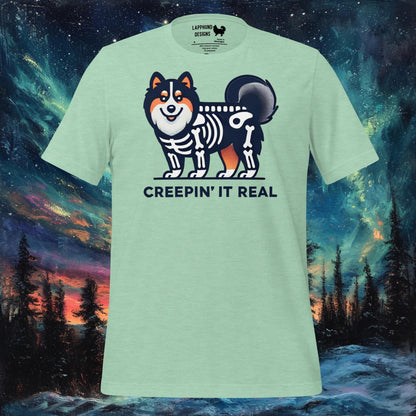 Mint t-shirt featuring a Finnish Lapphund in a skeleton costume with 'Creepin' It Real' text, perfect for Halloween and dog lovers.