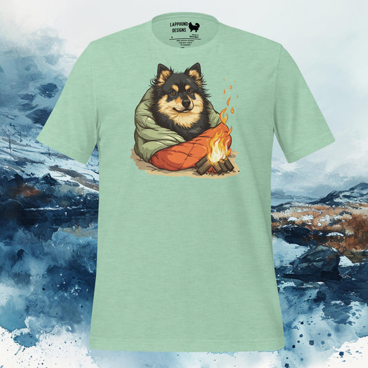 White t-shirt featuring a Finnish Lapphund wrapped in a sleeping bag beside a campfire, perfect for camping and outdoor-loving dog owners.