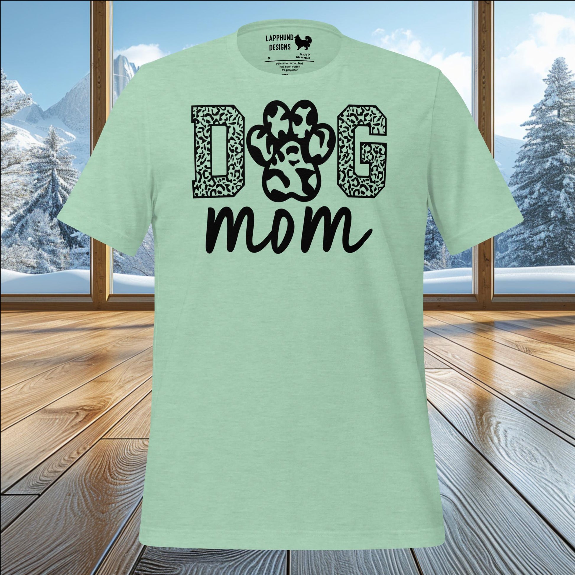 Paw Print Dog Mom t-shirt with bold text, perfect for dog moms who enjoy outdoor adventures and nature.