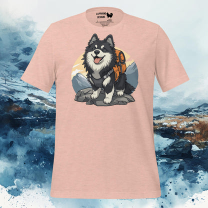 Peach t-shirt featuring a Finnish Lapphund with a hiking pack in front of a mountain, perfect for outdoor-loving dog owners and adventurers.