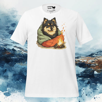 White t-shirt featuring a Finnish Lapphund wrapped in a sleeping bag beside a campfire, perfect for camping and outdoor-loving dog owners.