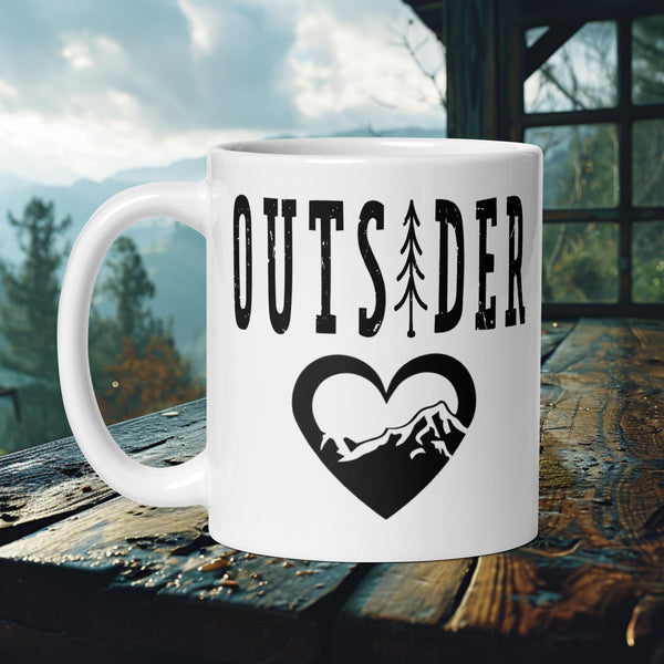 Finnish Lapphund Mug with "Outsider" text and heart-shaped mountain tree design—ideal for dog enthusiasts and nature lovers.  

