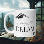 Finnish Lapphund Mug with "Living the Dream" text, mountain, and paw print—ideal for dog lovers and dreamers.  


