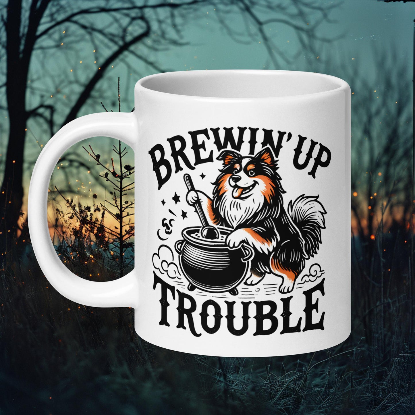 White ceramic mug featuring a Finnish Lapphund stirring a cauldron with the text 'Brewin' Up Trouble,' perfect for Halloween and dog lovers.