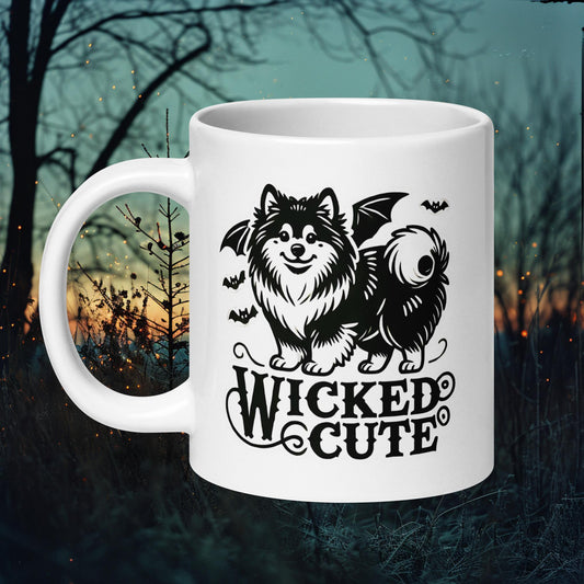 White ceramic mug featuring a Finnish Lapphund with bat wings and the text 'Wicked Cute,' perfect for Halloween and dog enthusiasts.